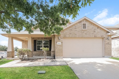 a house with a garage door in front of it